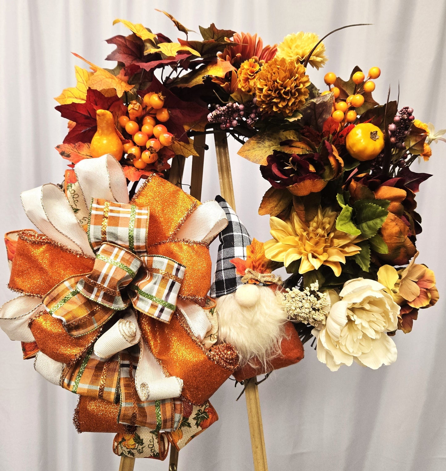 16″ grapevine wreath featuring a whimsical gnome surrounded by autumn foliage, pumpkins, gourds, and seasonal florals