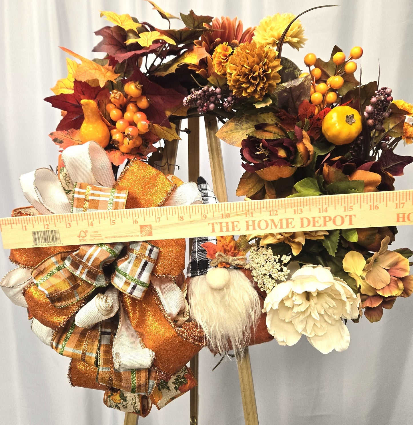 16″ grapevine wreath featuring a whimsical gnome surrounded by autumn foliage, pumpkins, gourds, and seasonal florals