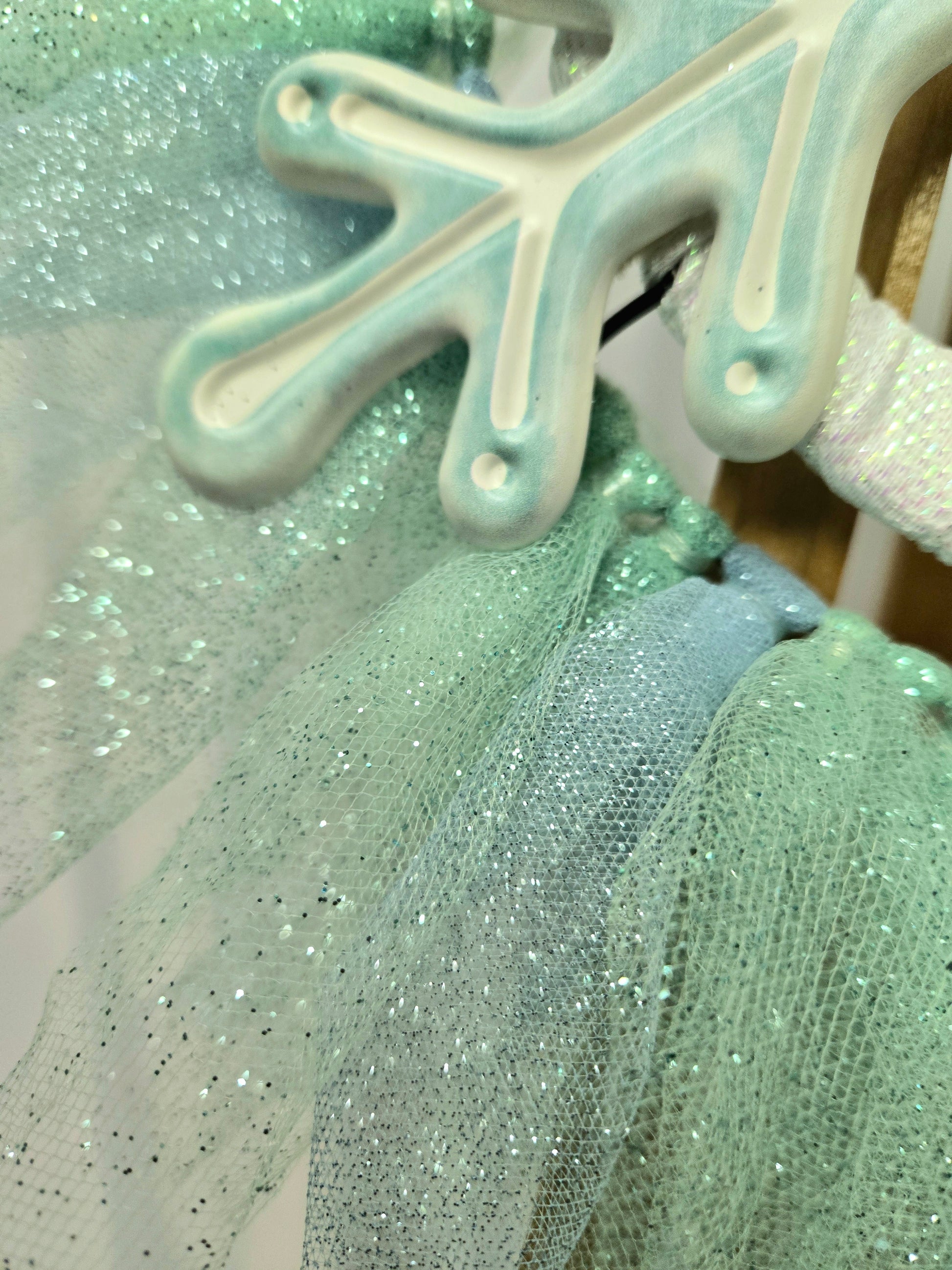 8″ wire wreath with teal and white metal snowflake, pale blue and teal mesh ribbons, and iridescent white bow