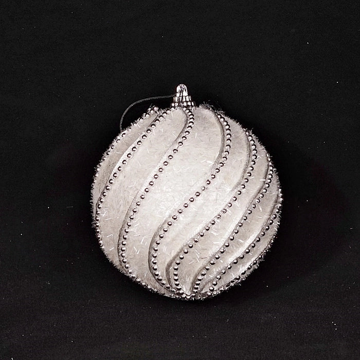 The glitter curly stripe ball ornament shown from the side to highlight its round shape.