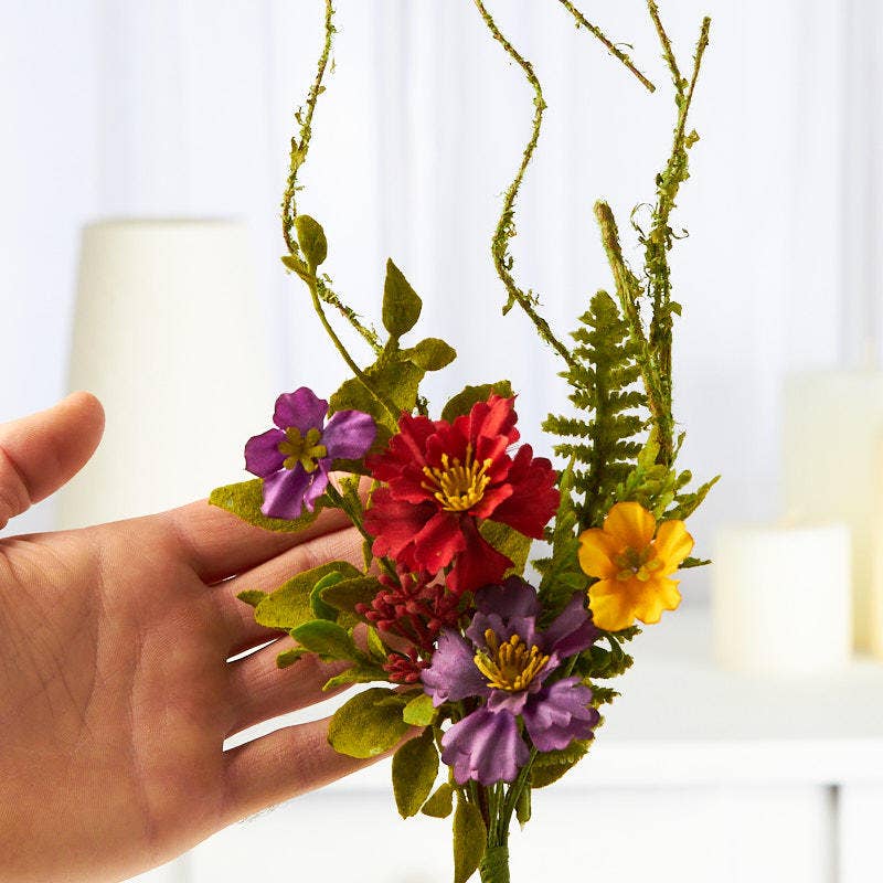 Close-up view of mixed wildflower pick showing colorful polysilk blooms and realistic flocked greenery details