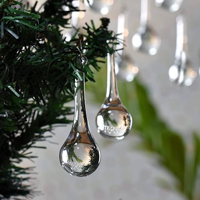 RRO Home clear teardrop ornament hanging on Christmas tree with holiday lights