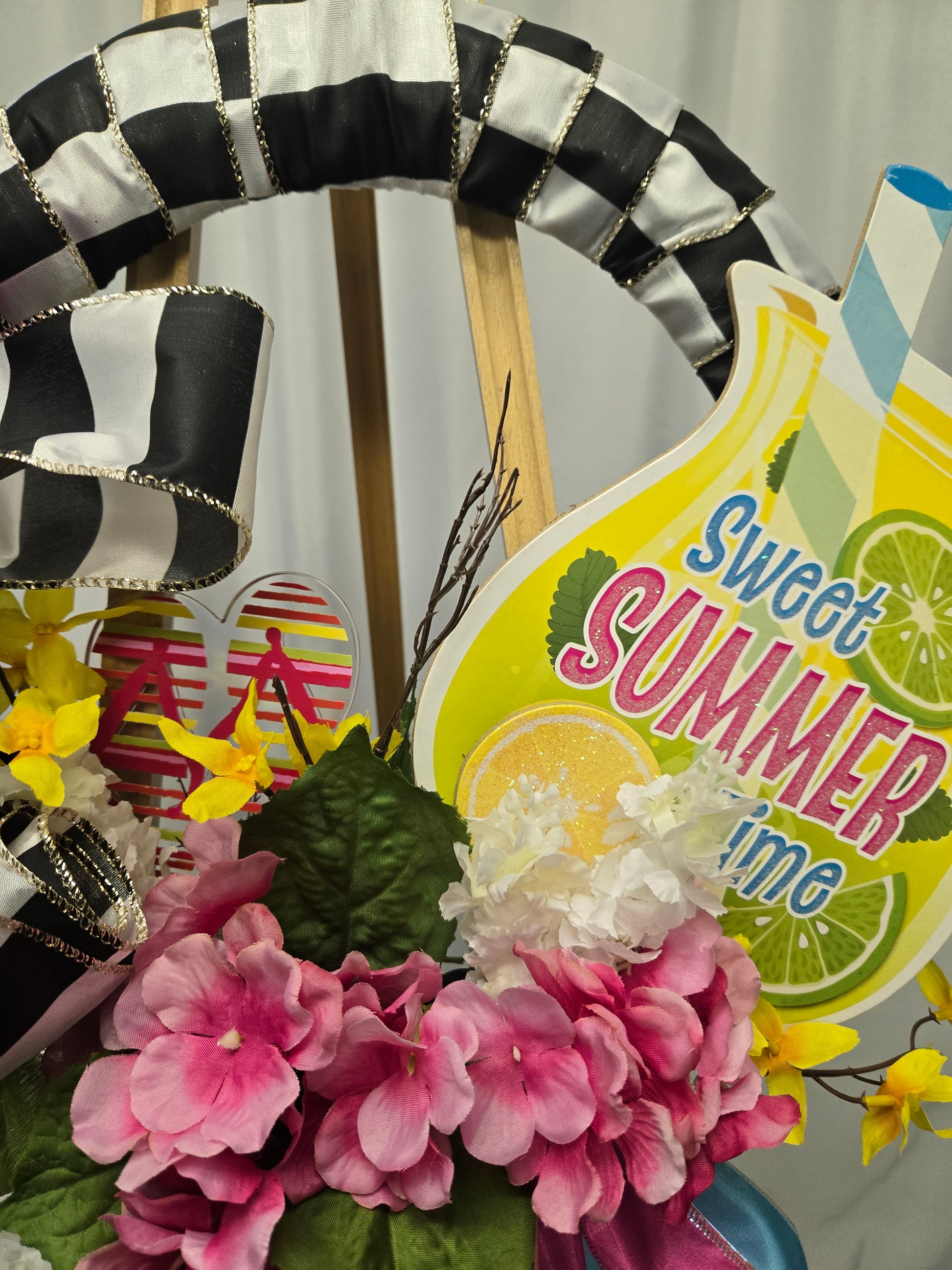 14″ summer wreath with bright blue, hot pink & yellow mesh, pink florals, flip-flops, ribbon accents, and a glass of lemonade
