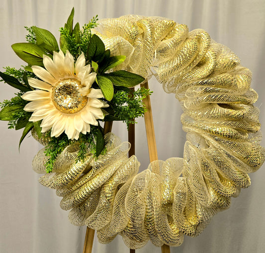 14″ wreath featuring a large cream and gold sunflower on a gold mesh base with greenery
