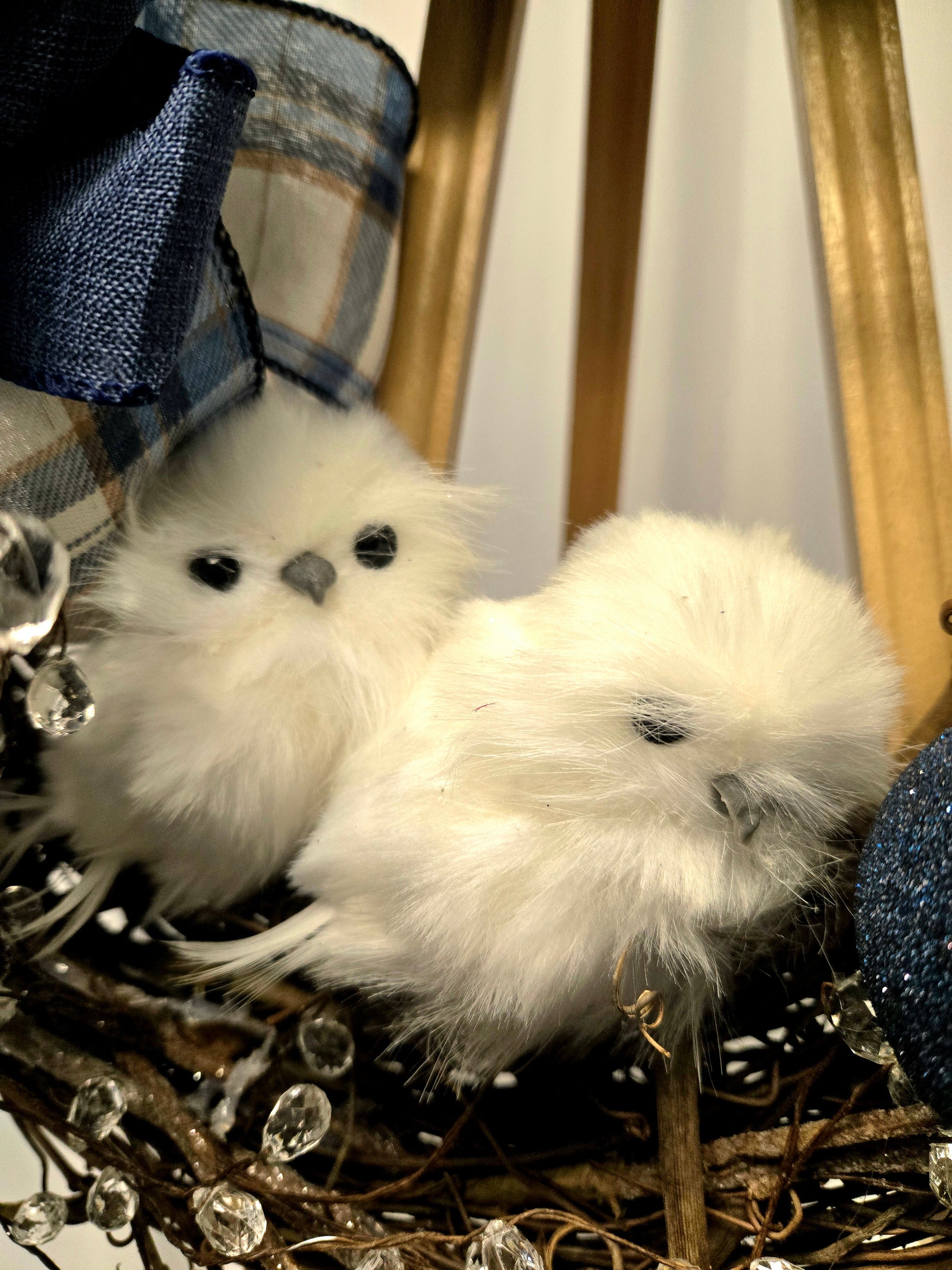 12″ grapevine wreath with two snowy white owls, ornamental balls, crystal picks, blue poinsettia, and multi-ribbon bow
