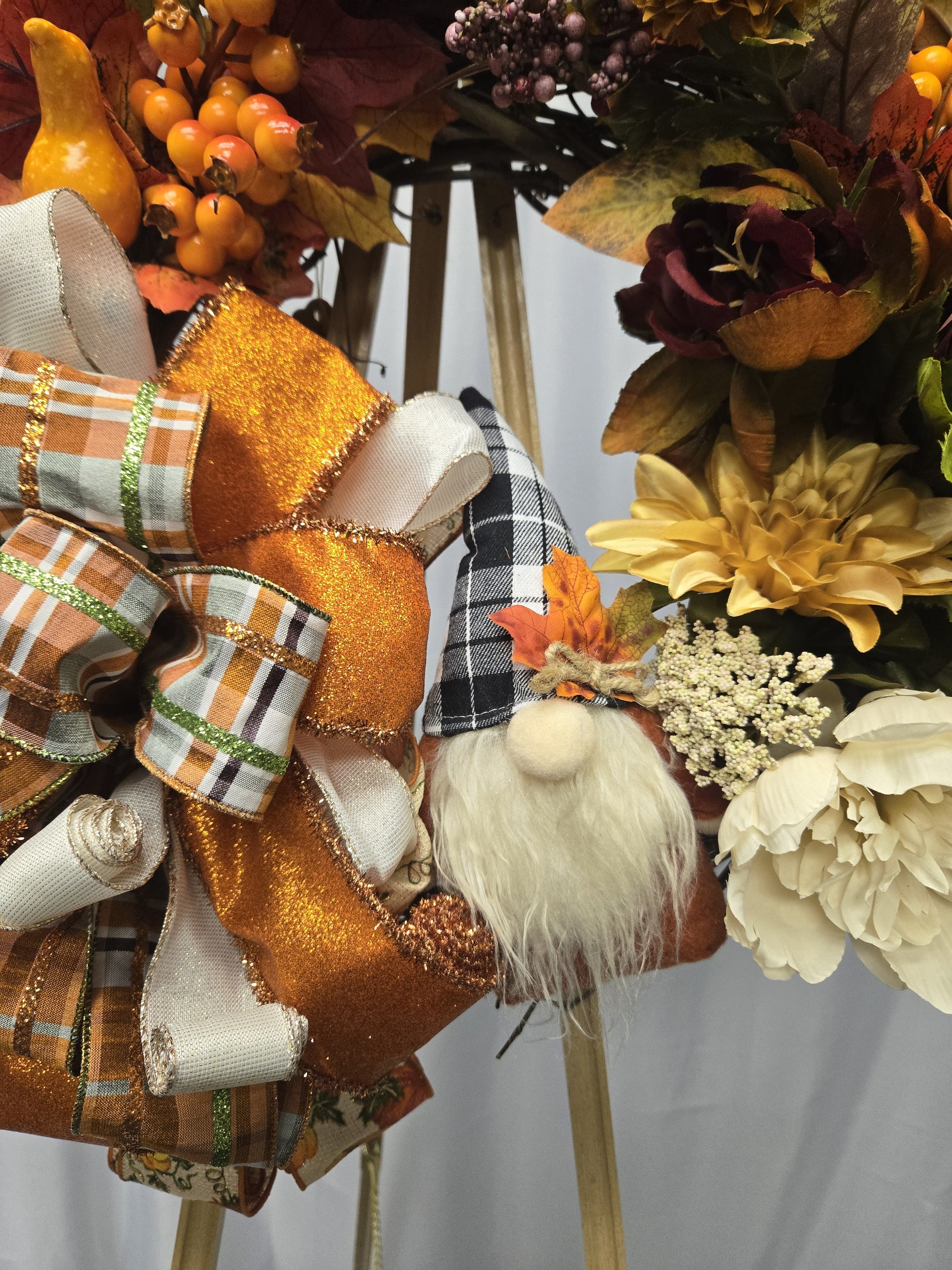 16″ grapevine wreath featuring a whimsical gnome surrounded by autumn foliage, pumpkins, gourds, and seasonal florals
