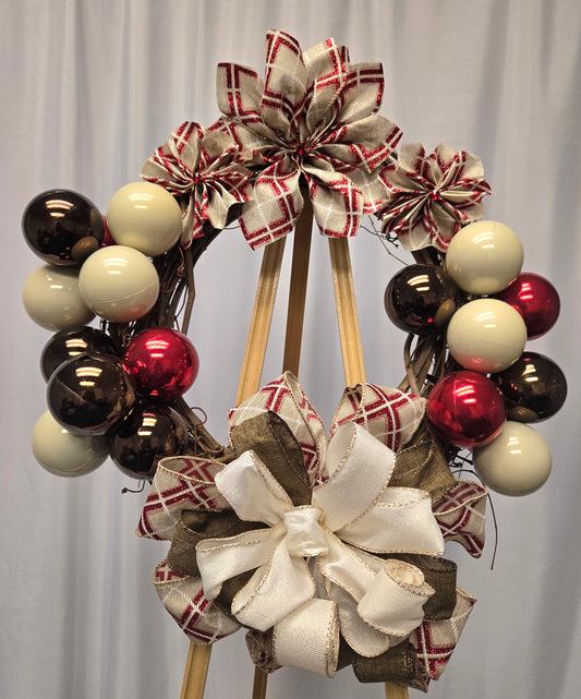 12″ Designer’s Choice holiday wreath with brown, red, and beige ornaments, poinsettia ribbon flowers, and multi-ribbon bow
