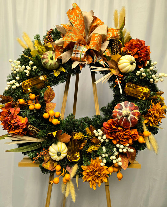 16″ fall wreath with orange, brown, and cream florals, berries, pumpkins, jewels, and coordinating bow

