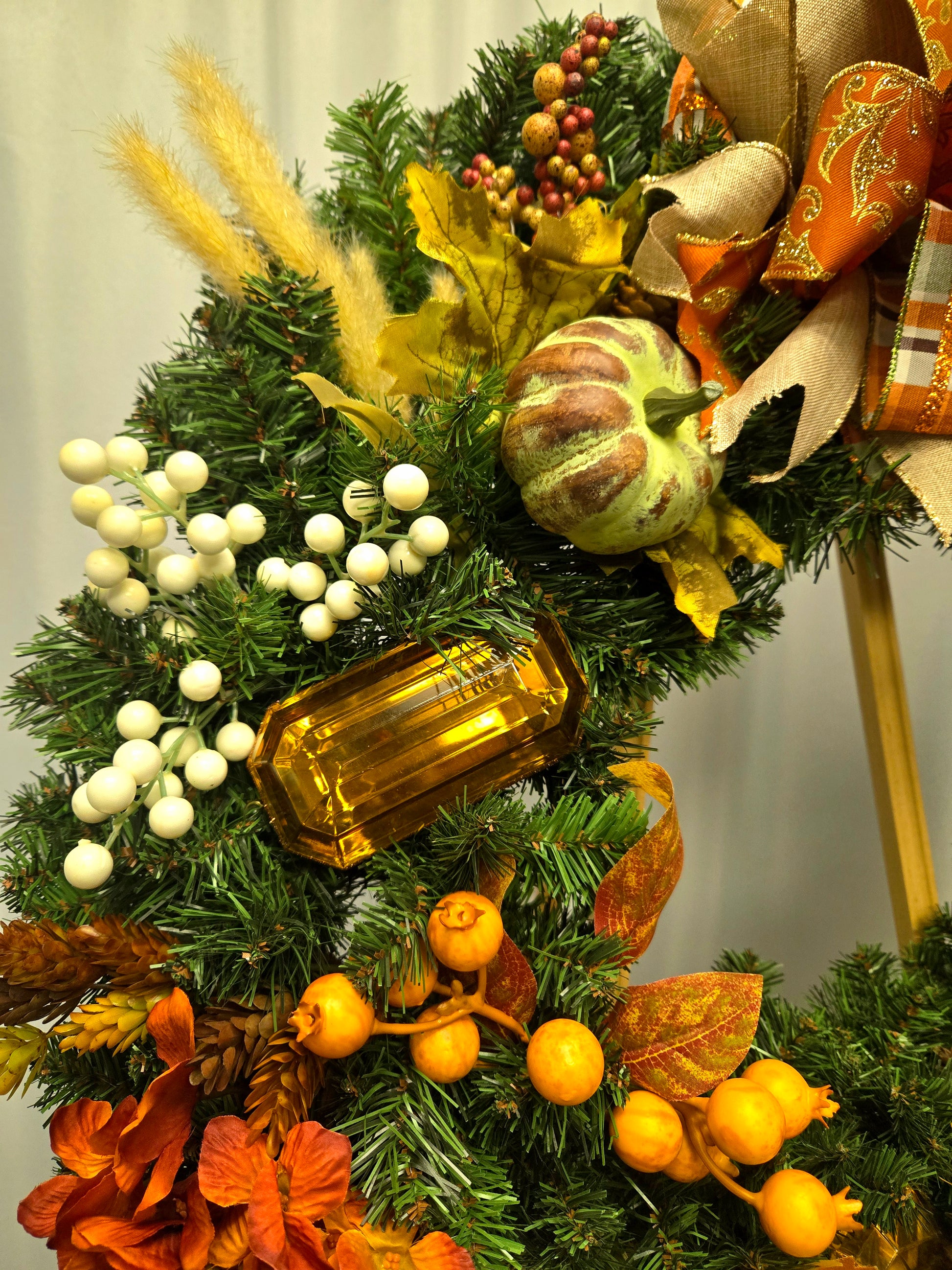 16″ fall wreath with orange, brown, and cream florals, berries, pumpkins, jewels, and coordinating bow

