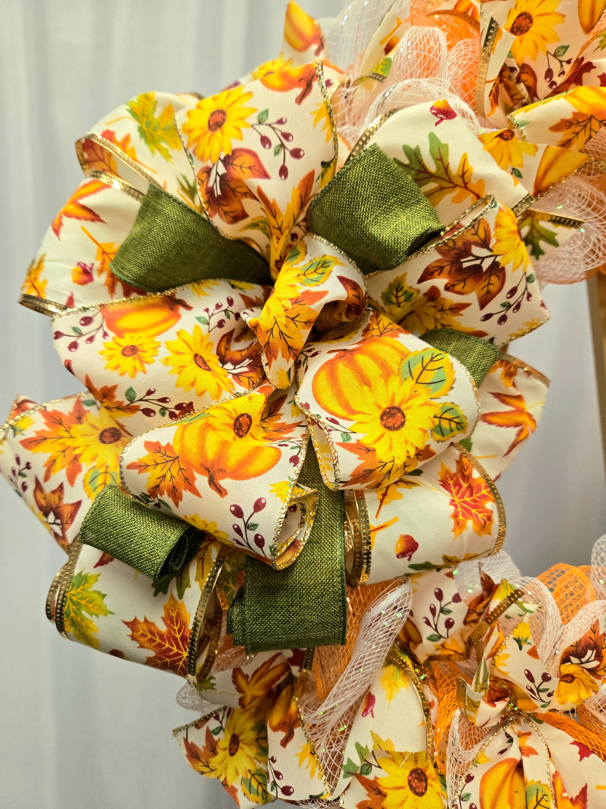 16″ fall wreath with orange, yellow, white & green deco-mesh and fall-themed ribbon on a wire wreath form
