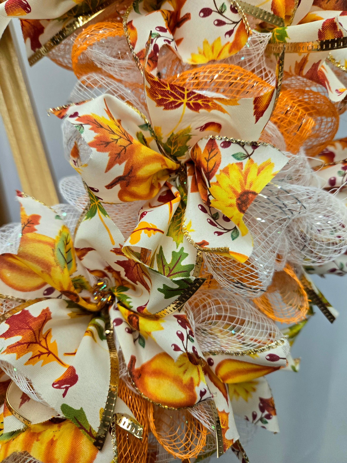 16″ fall wreath with orange, yellow, white & green deco-mesh and fall-themed ribbon on a wire wreath form
