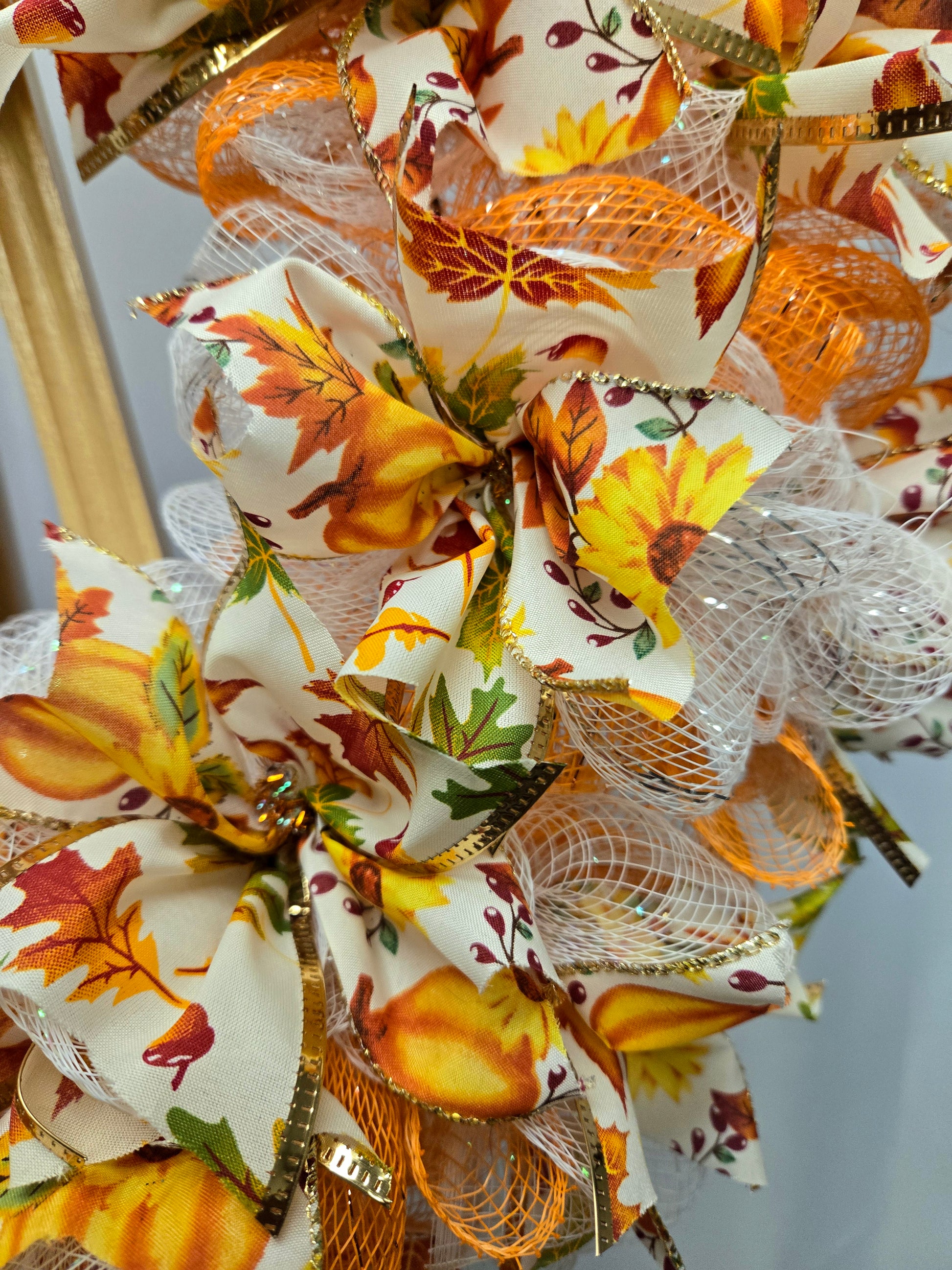 16″ fall wreath with orange, yellow, white & green deco-mesh and fall-themed ribbon on a wire wreath form
