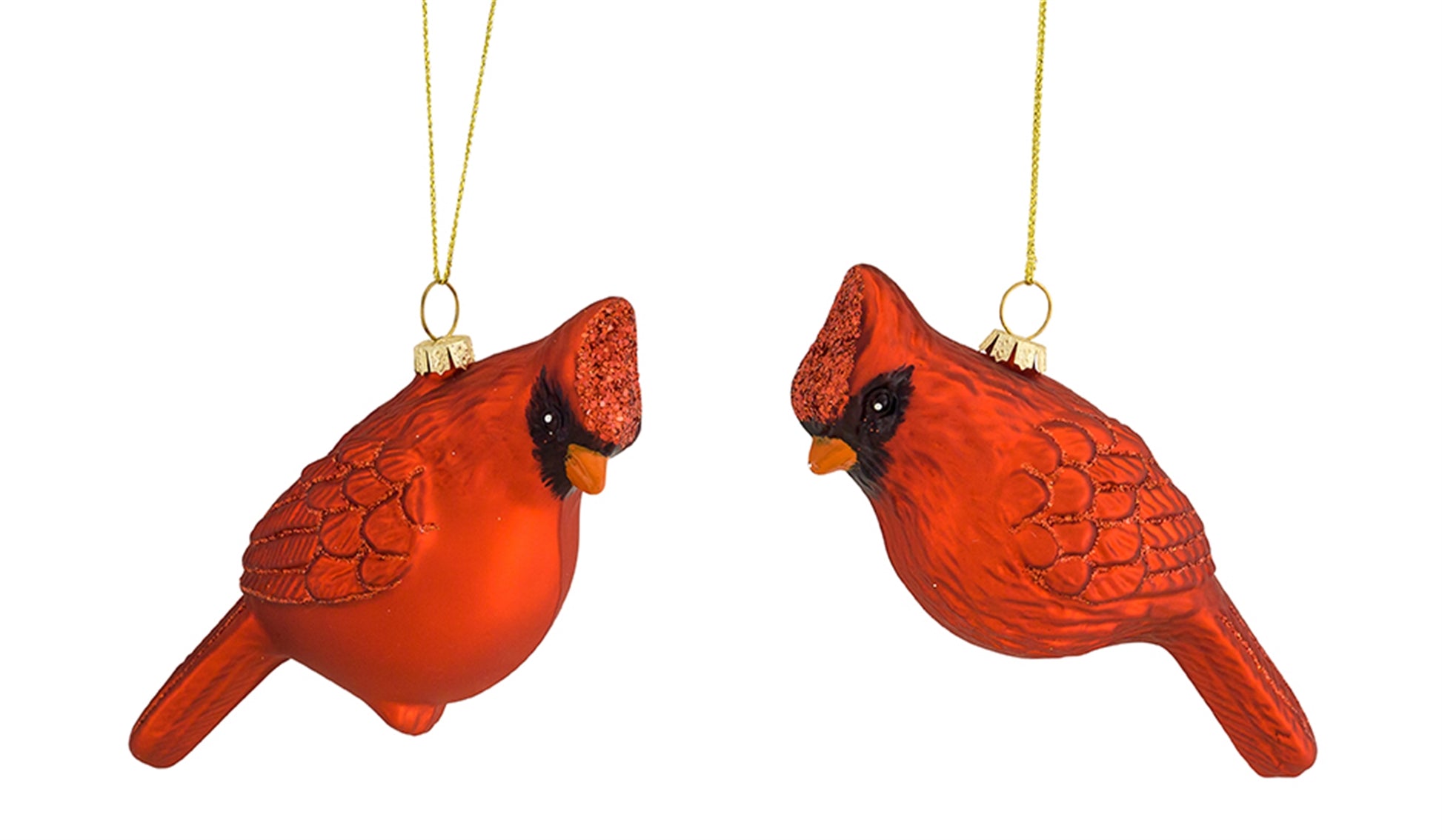 A pair of vibrant red glass cardinal bird ornaments with textured wings and sparkling crests, hanging from gold strings.