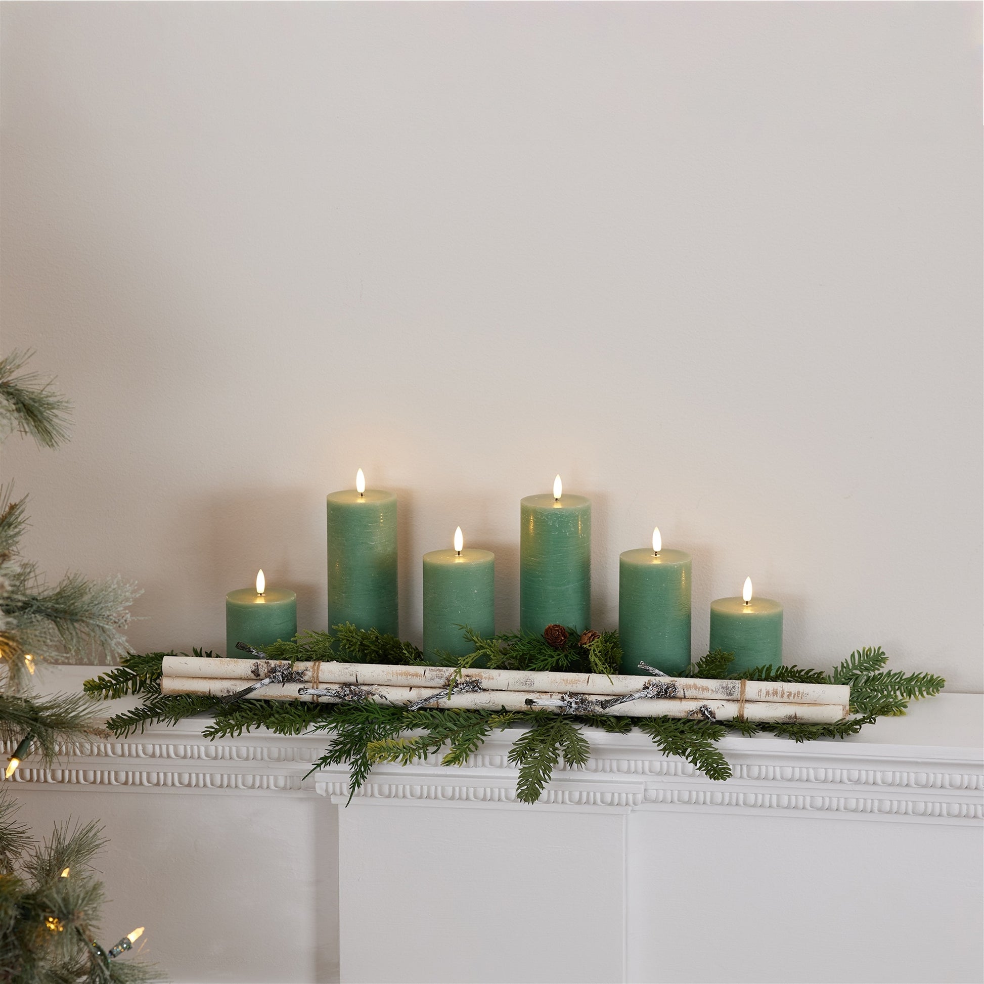 Rustic birch logs used in a holiday centerpiece arrangement