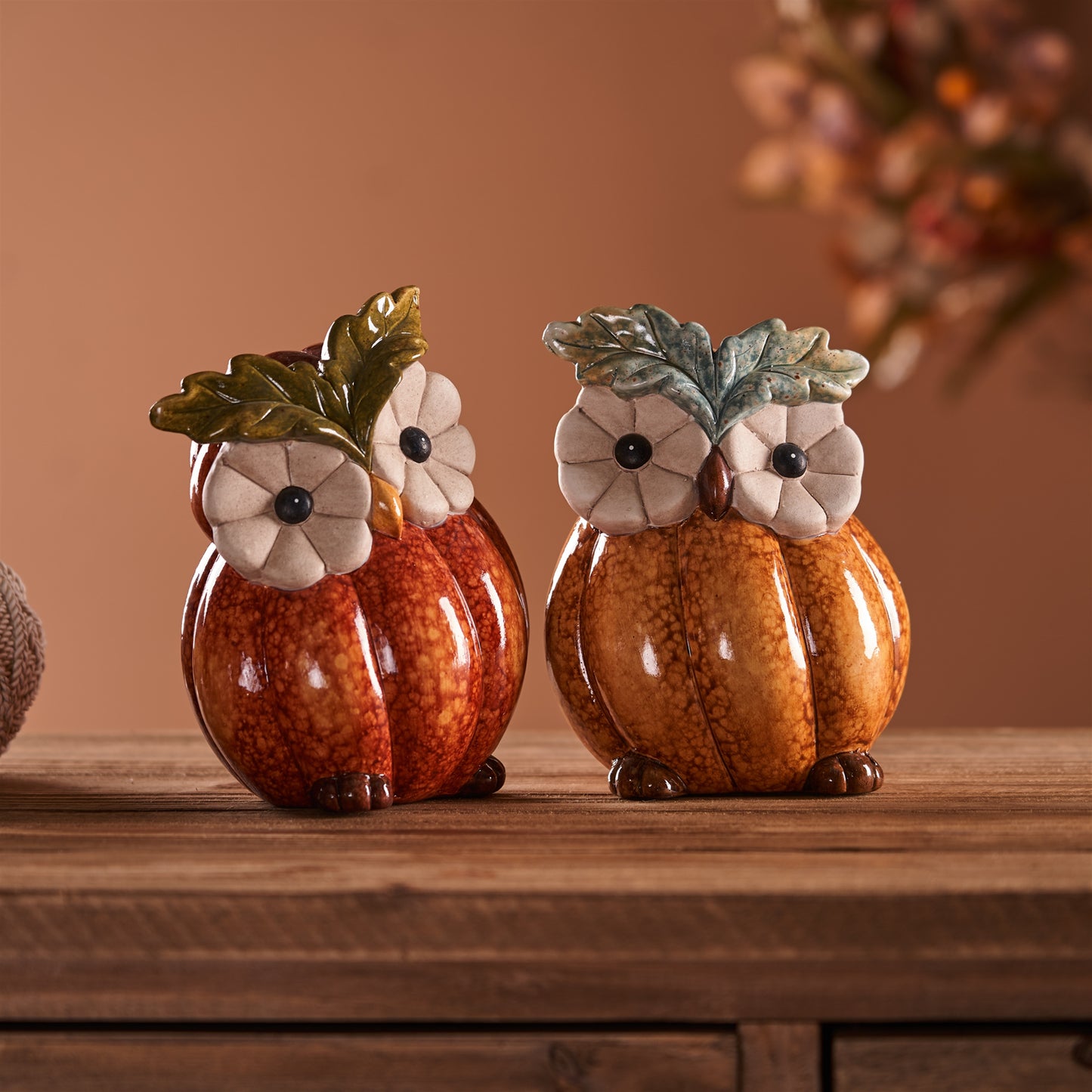 Two terra cotta owl figurines with pumpkin and leaf accents for fall décor
