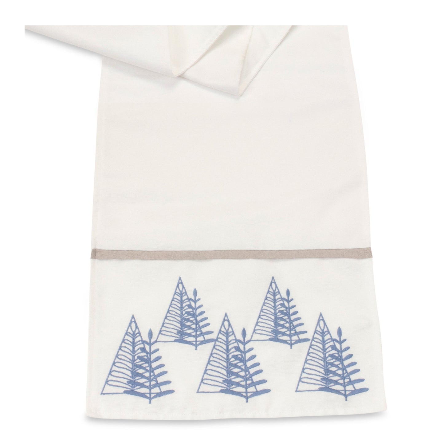 Close-up of minimalist embroidered pine tree on a white table runner