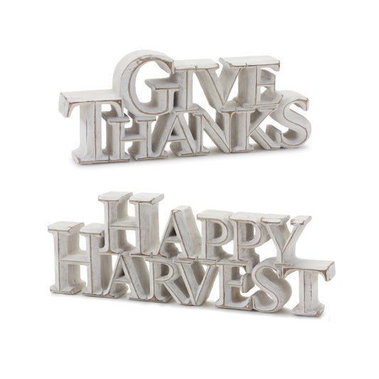 Two white-washed tabletop resin signs reading “Happy Harvest” and “Give Thanks”

