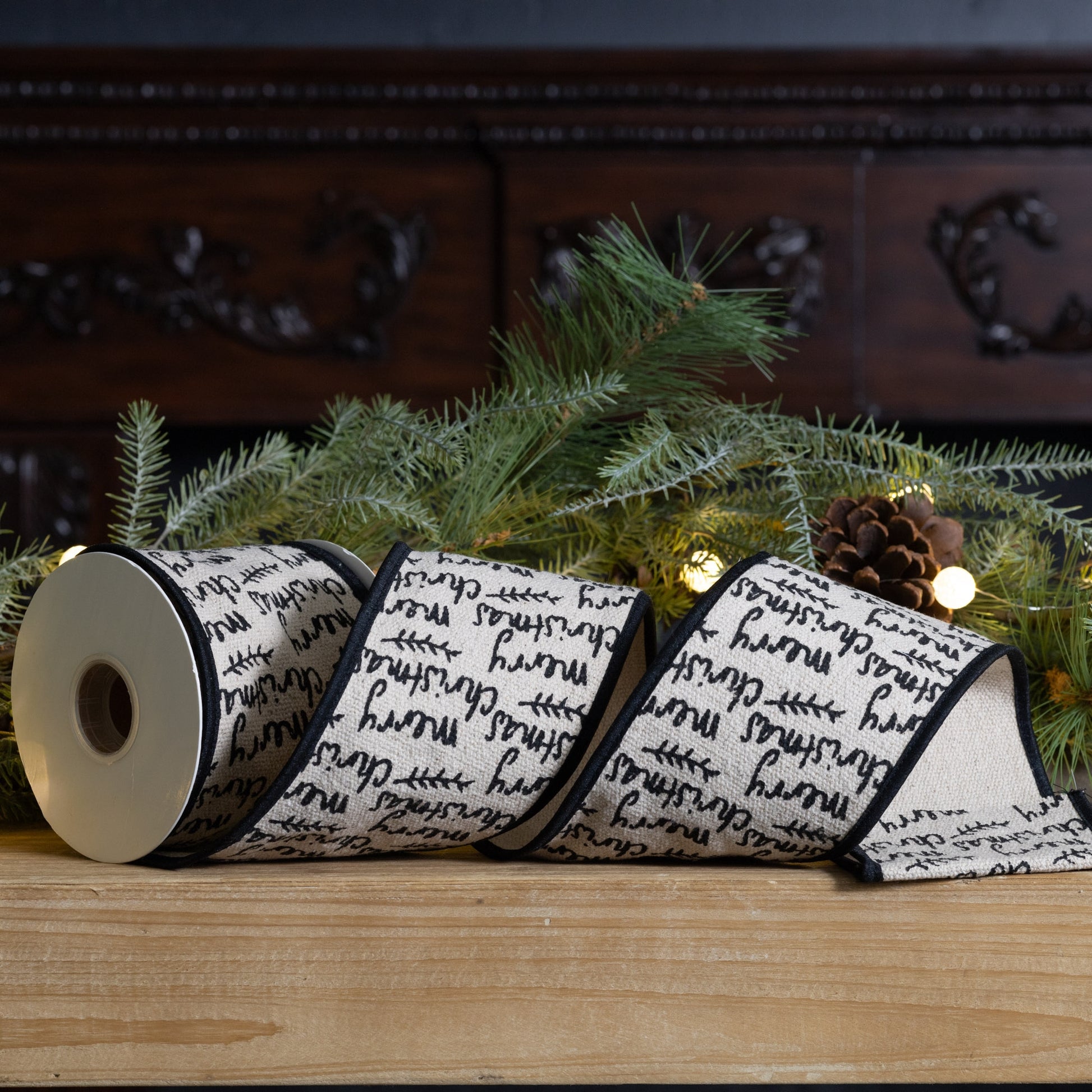 Wired cotton ribbon 4″ × 5 yd featuring black and beige “Merry Christmas” text—perfect for bows, wreaths, and festive crafts
