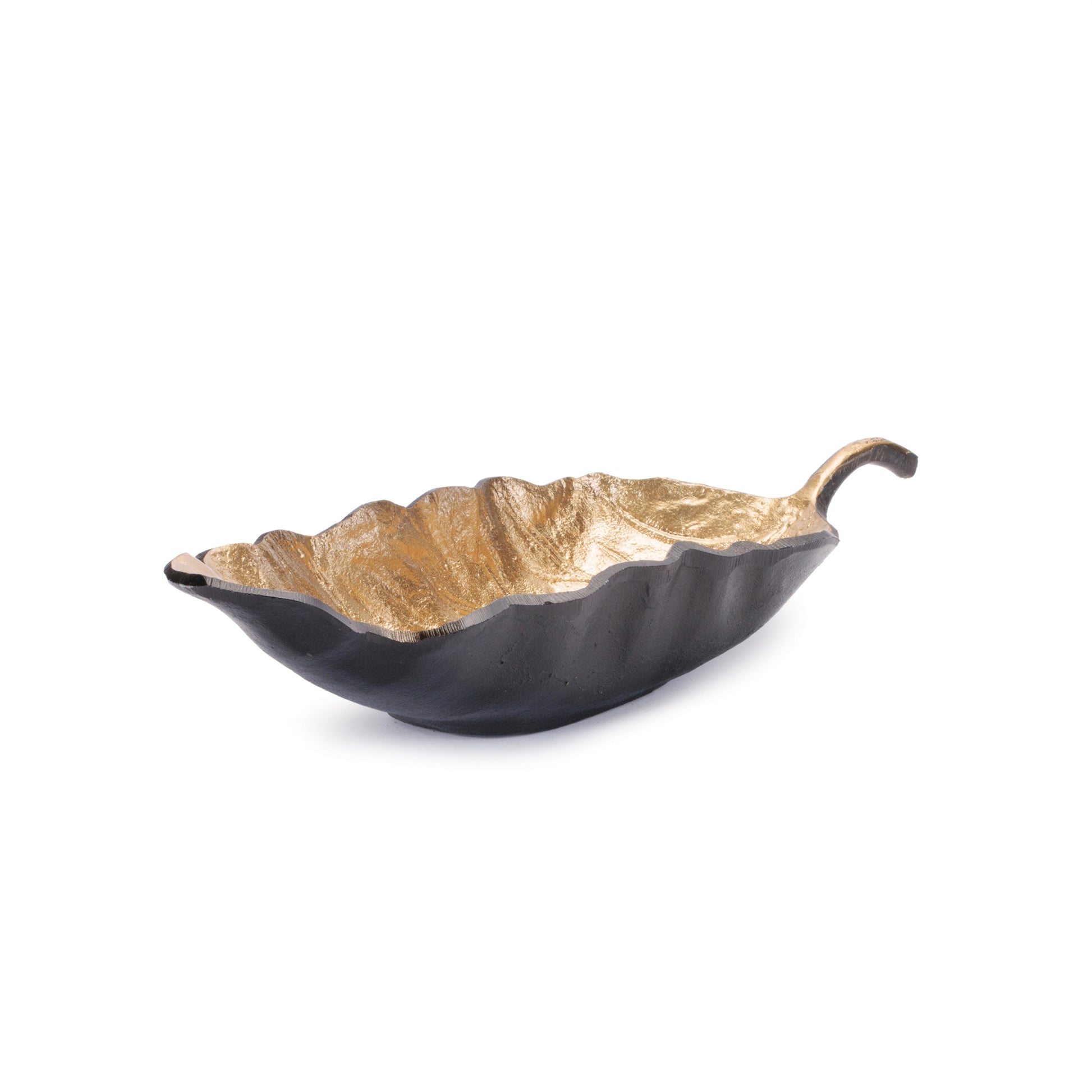 Long metallic leaf bowl styled as a centerpiece on a dining table