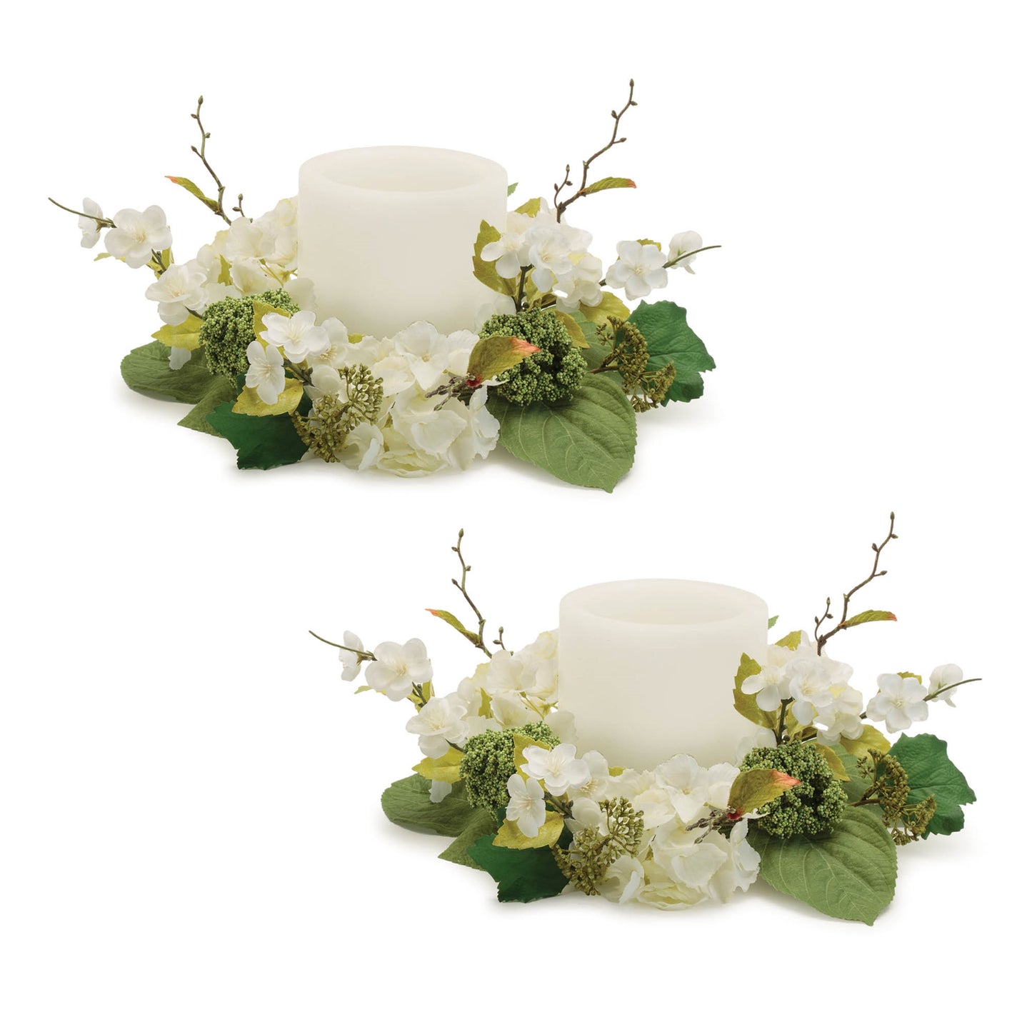 A pair of white hydrangea candle rings creating an elegant centerpiece with pillar candles inside.