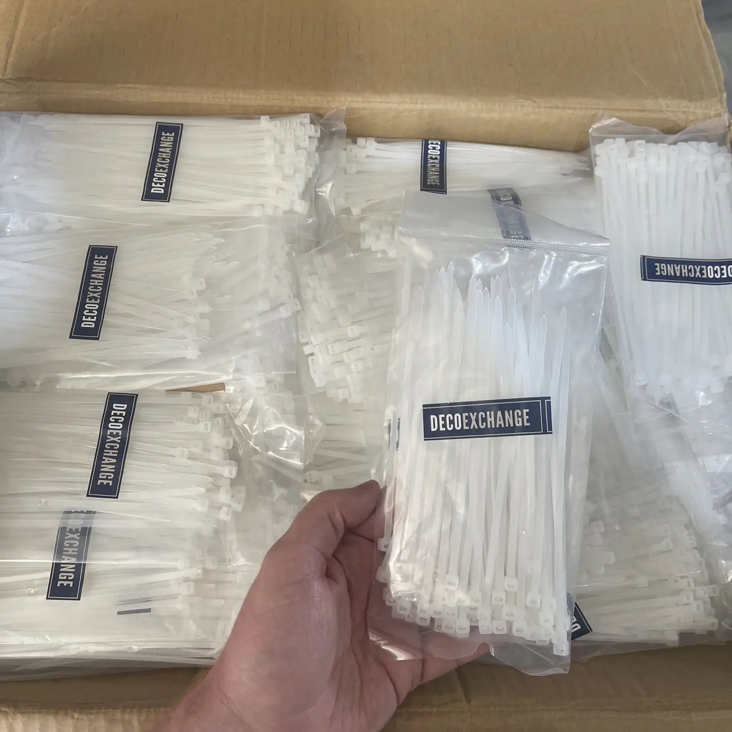 Bag of 100 six-inch durable plastic cable ties for organization and craft projects
